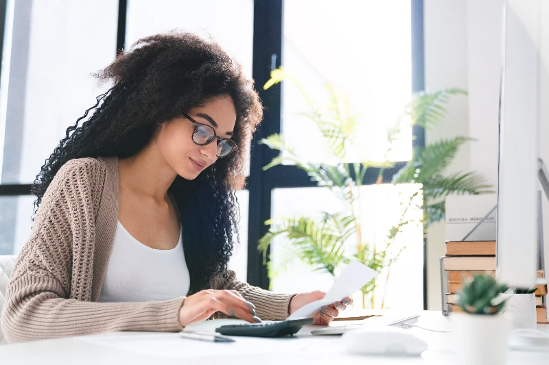 Young woman using a mortgage calculator